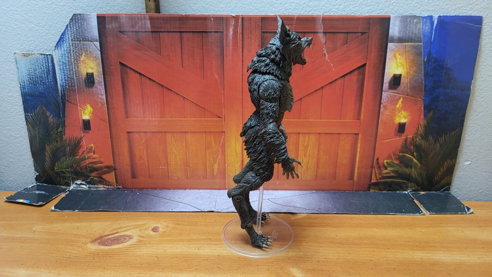 A side view of the figure, facing the right, in a neutral pose, with the open mouth head on