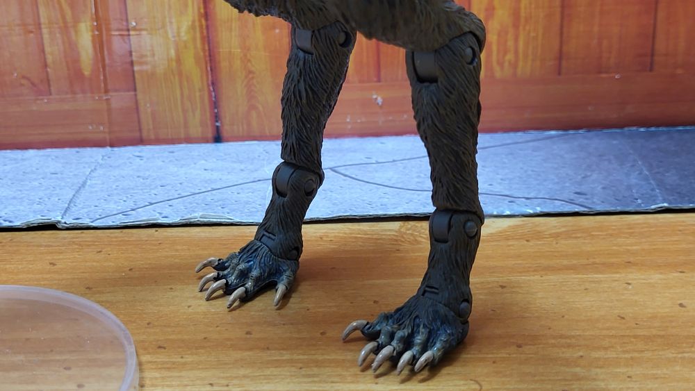 Close up front view of the feet of the figure, facing slightly to the right side