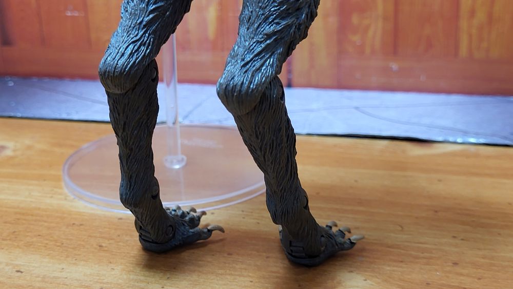 Close up back view of the feet of the figure, facing slightly to the left side