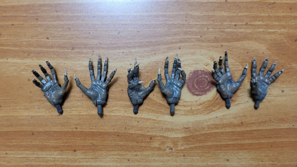 A view of the three pairs of hands from the bottom side view, showing the palms